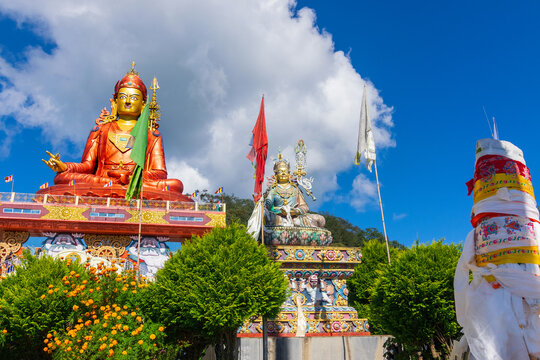 Wide angle view of Holy statue of Guru Padmasambhava or born from a lotus, Guru Rinpoche, Blue sky and white clouds, Samdruptse, Sikkim, India.