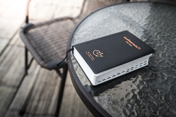 Holy bible placed on table in morning time. Christian concept used to learn about God.