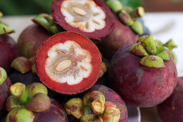 Mangosteen fruit, ripe, cut off the peel, white inner flesh Mangosteen is Asia's queen of fruits....