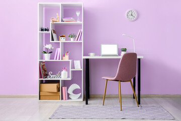 Interior of office with modern workplace and shelving unit