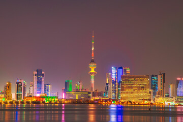 Kuwait Skyline view from beach during the national day celebration. Kuwait National day lights on the building and Kuwait flag lights during the night time. Kuwait City skyline view....