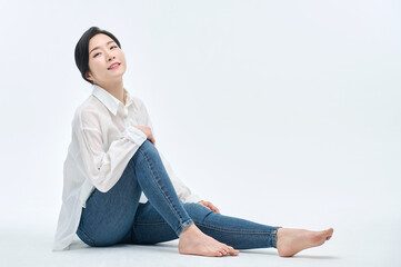 beautiful woman in blue jeans with a white background