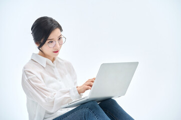 beautiful woman using a laptop on a white background