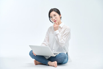beautiful woman using a laptop on a white background