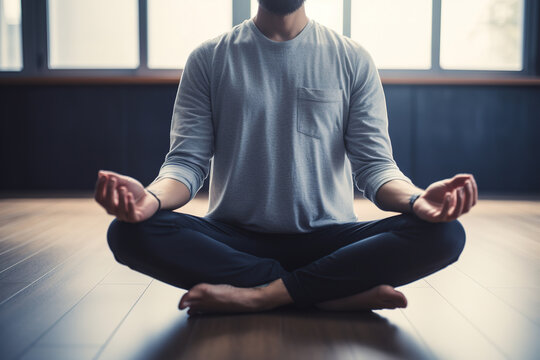 Meditating unrecognizable barefoot man in casual clothes practicing yoga while sitting in the lotus position indoors. Relaxation, mental health. Generative AI