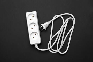 Electric extension cord on black background