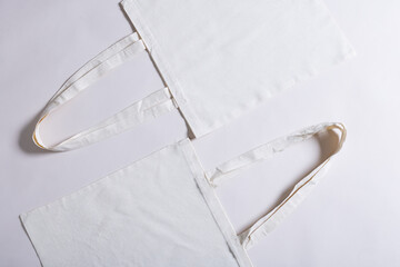 High angle view of two white canvas bags with copy space on white background