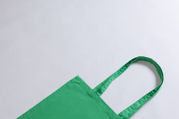 High angle view of green canvas bag with copy space on white background