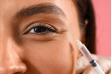 Young woman receiving filler injection in face, closeup © Pixel-Shot