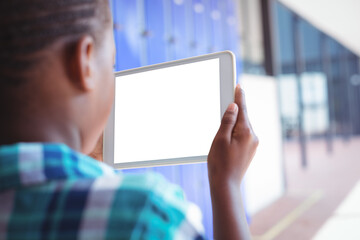 Schoolboy photographing corridor through digital tablet 