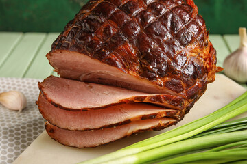 Board with tasty smoked ham on table, closeup