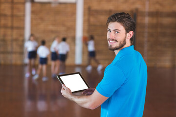 Naklejka premium Sports teacher using digital tablet