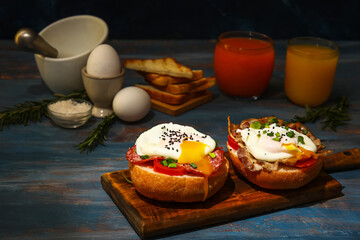 Board with tasty eggs Benedict on table