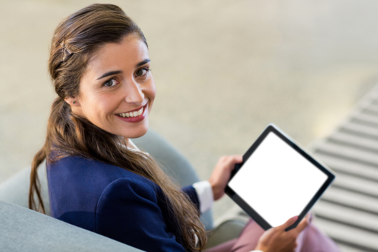 Cheerful businesswoman holding digital tablet - Powered by Adobe