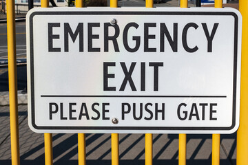 Emergency exit sign. Exterior, exit sign on a gate on a street