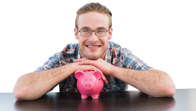 Portrait of smiling man sitting at desk with pink piggy bank 