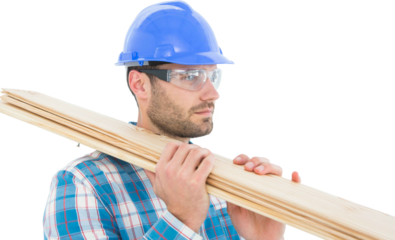 Confident carpenter carrying wooden planks