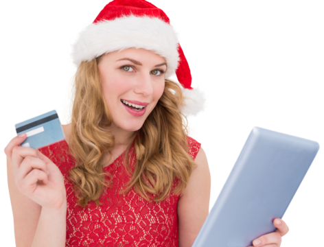 Festive blonde woman using her credit card and tablet pc
