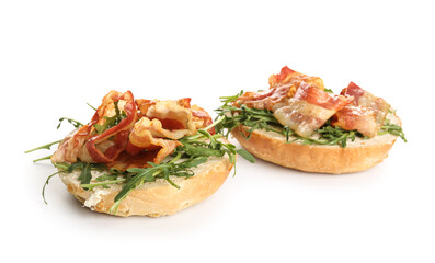 Tasty bacon bruschettas with arugula on white background
