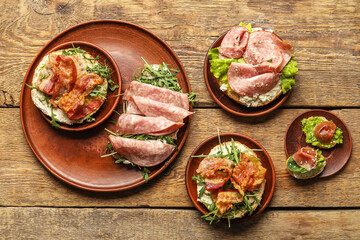 Different bruschettas on wooden background