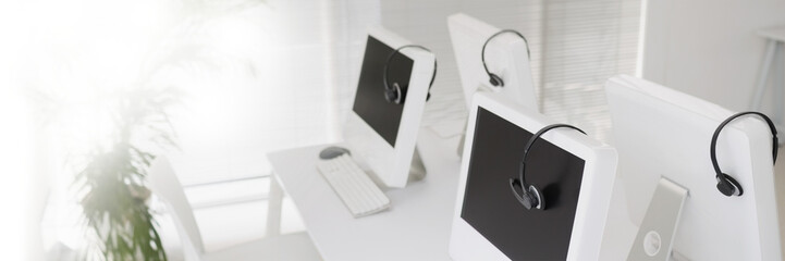 Desktop computers with headphones on desk
