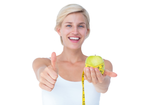 Happy woman holding an apple with thumbs up