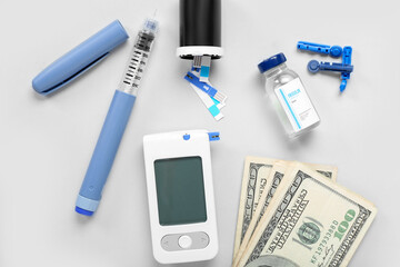 Medical supplies for patient with diabetes and money on light background. Expensive medicine concept