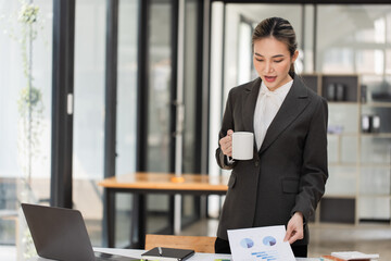 Happy excited young successful asian business woman working at the table in office, Businesswoman and finance marketing.