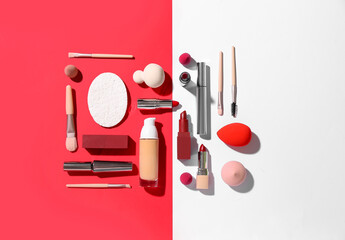 Decorative cosmetics with makeup brushes and sponges on color background