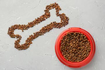 Bone made of dry pet food on grunge background