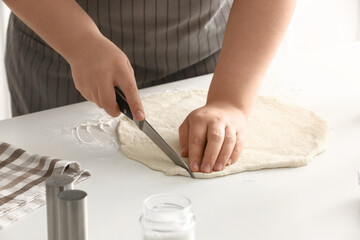 Woman preparing Italian Grissini at table, closeup