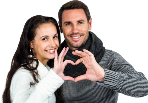 Smiling couple making heart shape with hands