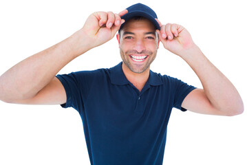 Fototapeta premium Smiling delivery man wearing cap on white background