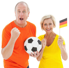 Happy german couple cheering at camera holding ball
