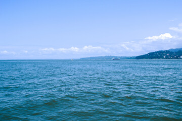 Seascape on a warm sunny day. Beautiful blue sea and island.