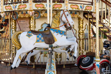 Fototapeta na wymiar detail view of a classic and historic merry-go-round carousel with a horse and race car