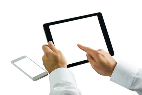 Businessman using digital tablet next to smartphone