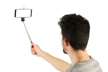 Casual man using a selfie stick