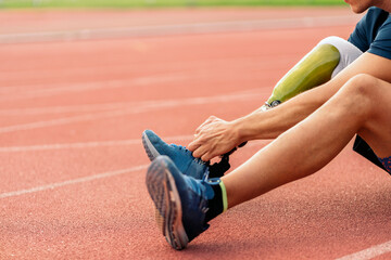 Close up disabled man athlete with leg prosthesis.