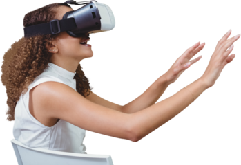 Young woman looking through virtual reality simulator while sitting on chair