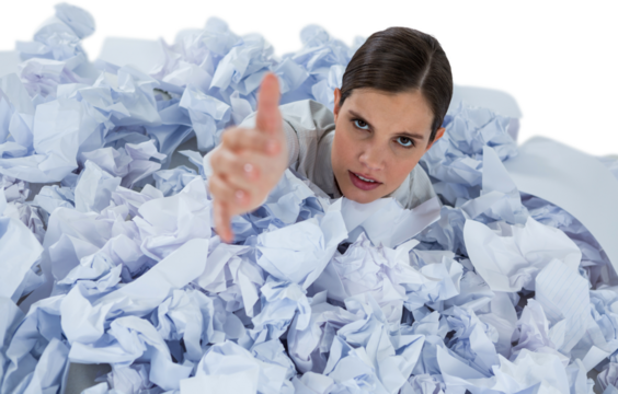Conceptual image of woman in heap of crumple paper asking for help