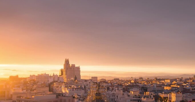 Madrid rooftops Gran Via Telefonica building skyline during colorful sunset with beautiful clouds  during spring  establishing shot