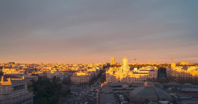 Timelapse Madrid aerial view of Cibeles town hall and retiro park during colorful sunset with beautiful clouds