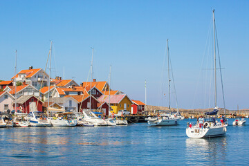 Fototapeta na wymiar Sailboat on its way into Grundsund harbor on the Swedish west coast