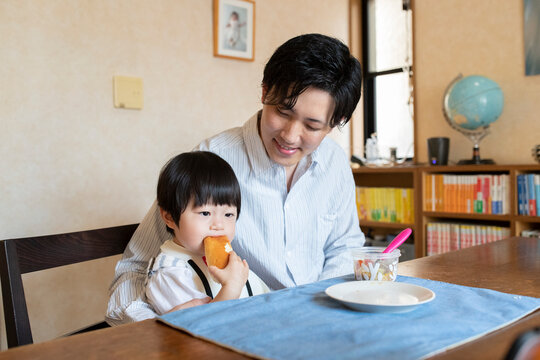 パンを食べる子どもと父親