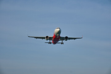 Fototapeta na wymiar Airplane landing on blue sky background.