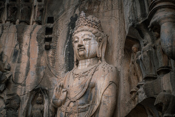 Fototapeta na wymiar Famous Longmen Grottoes (statues of Buddha and Bodhisattvas carved in the monolith rock near Luoyang in Hennn province, China), UNESCO WORLD HERITAGE site
