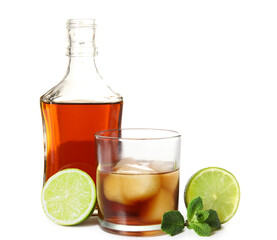 Bottle and glass of cold rum with lime on white background
