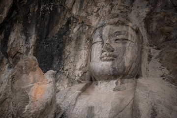 Fototapeta na wymiar Luoyang The Buddha of Longmen Grottoes in China, close up with copy space for text
