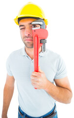Manual worker looking through monkey wrench